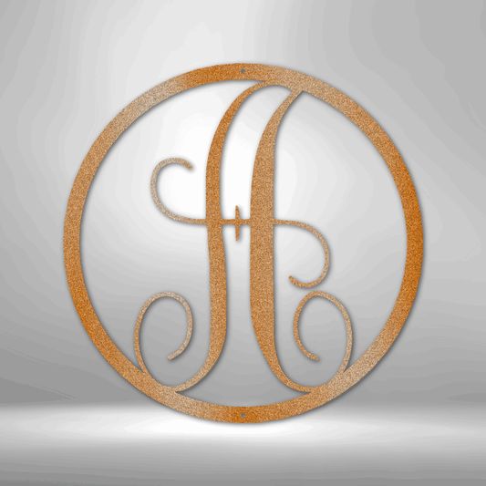 Circular monogram featuring an ornate letter ’A’ in a golden or bronze color.