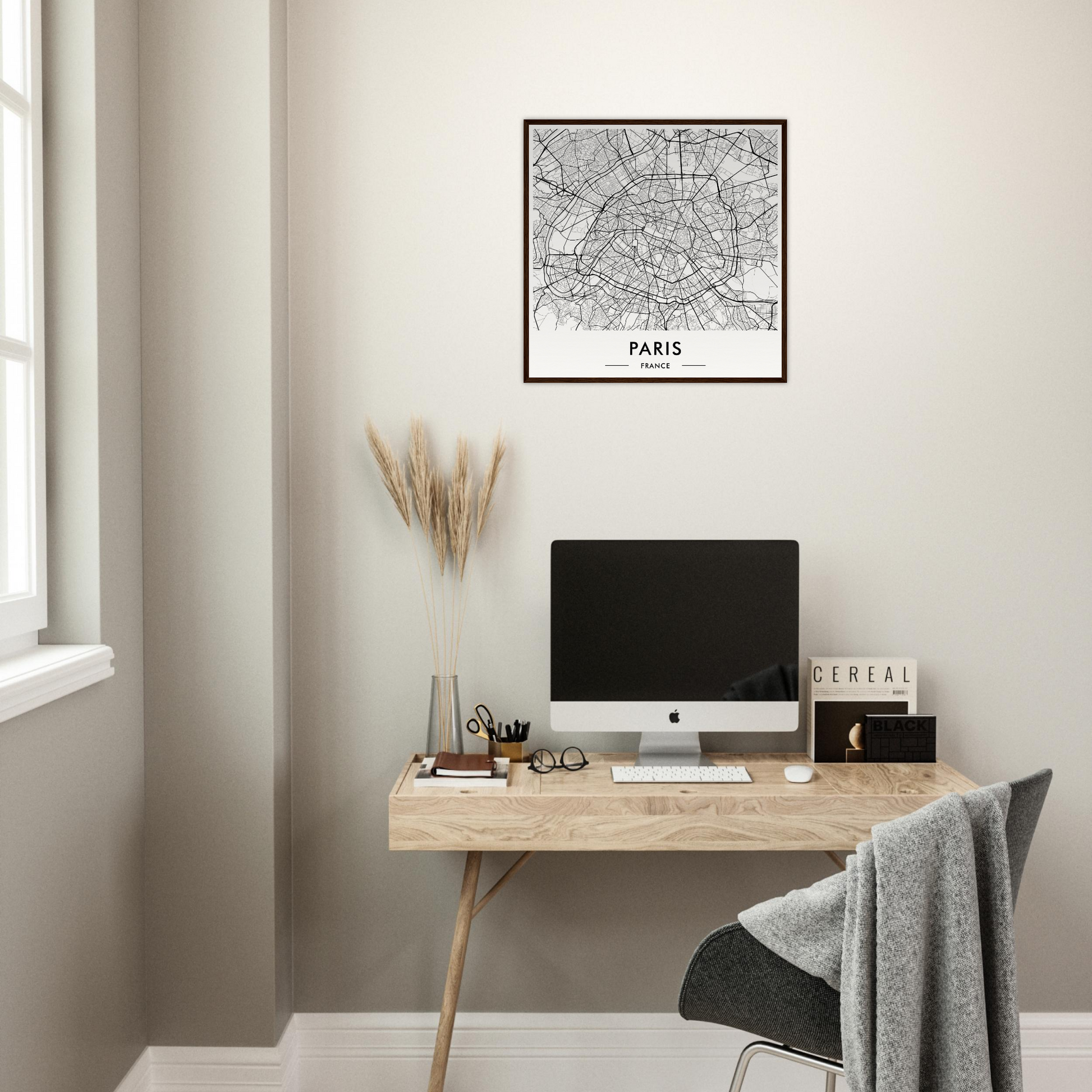 Minimalist wooden desk with a computer monitor and office accessories.