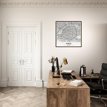 Wooden desk with office supplies and a framed map of Paris on the wall above.