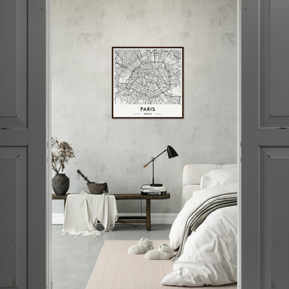 Framed map of Paris hanging on a white wall.