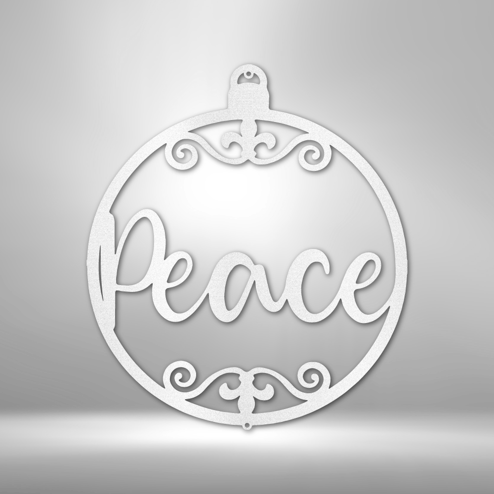 Ornamental circular pendant with the word ’Peace’ inscribed in cursive lettering, adorned with decorative swirls.