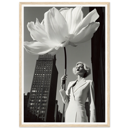 Woman in a white dress holding an oversized flower against an urban backdrop.