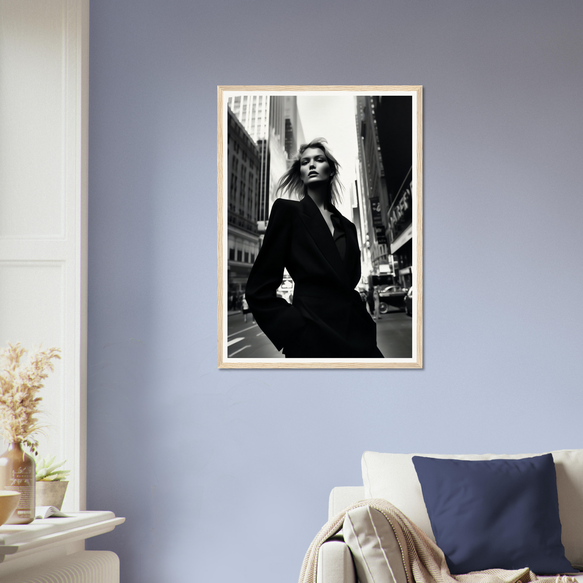 Framed black and white photograph of a woman in a dark coat standing on a city street.