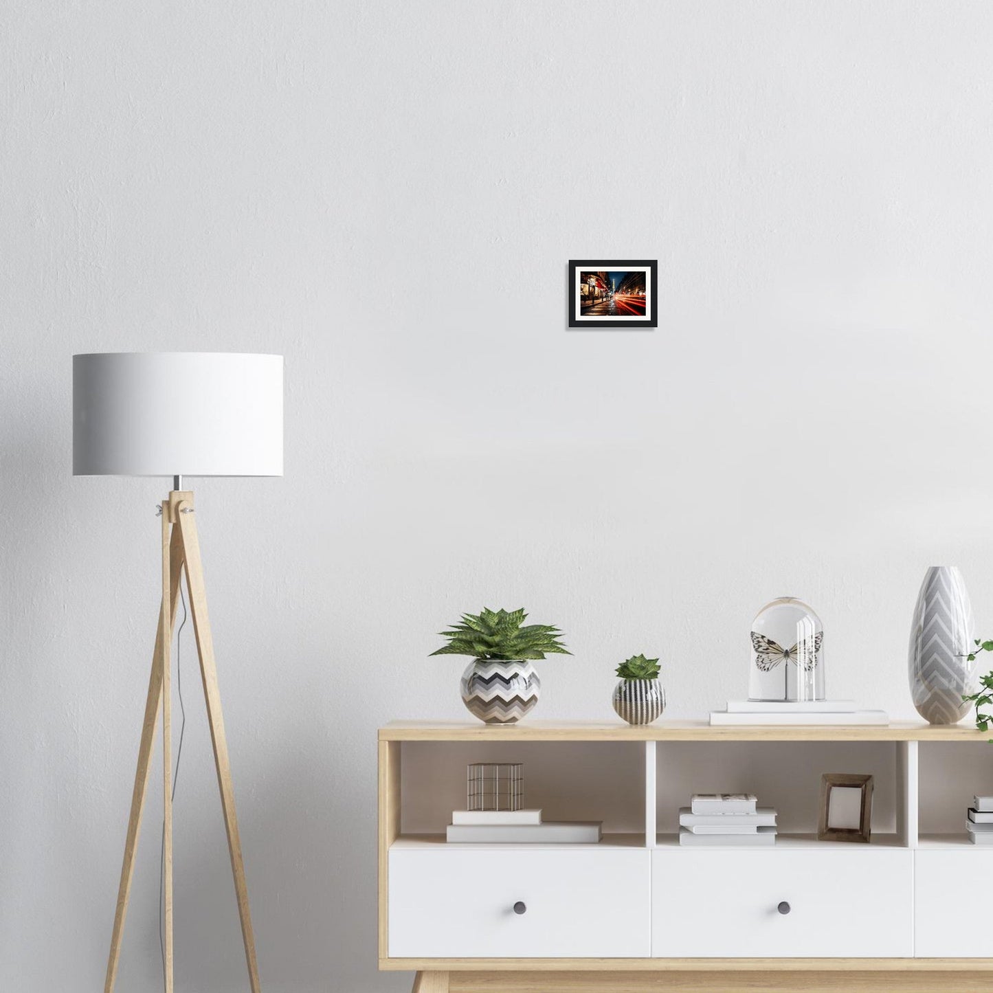 There is a picture of a living room with a white couch and a white table