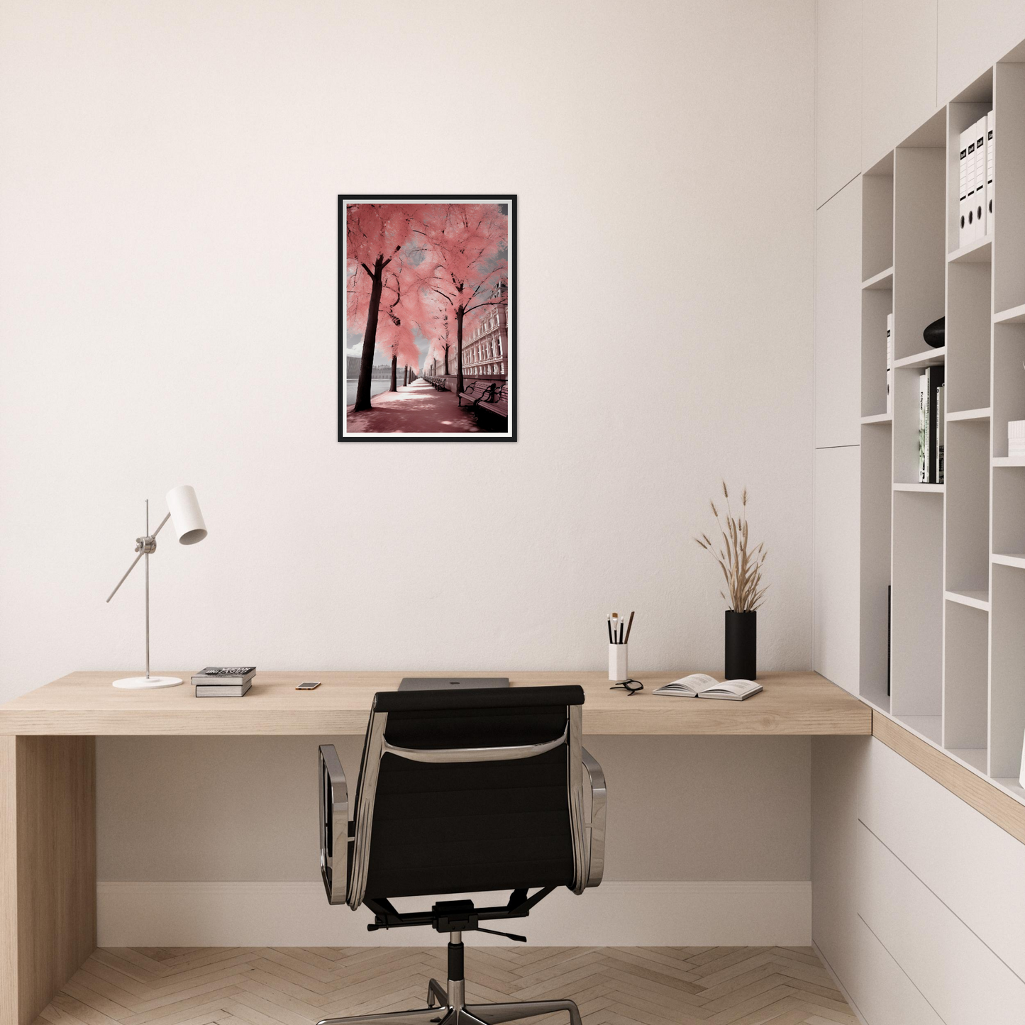 A pink and black painting on a wall above a desk