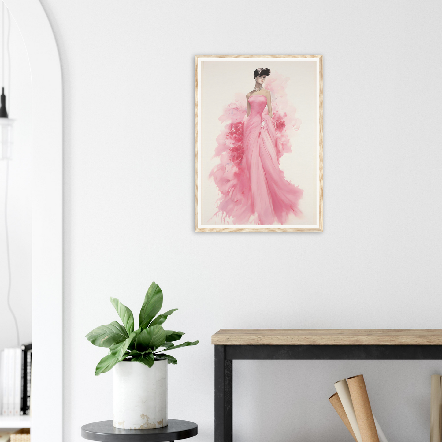 A pink dress hangs on a wall above a black table