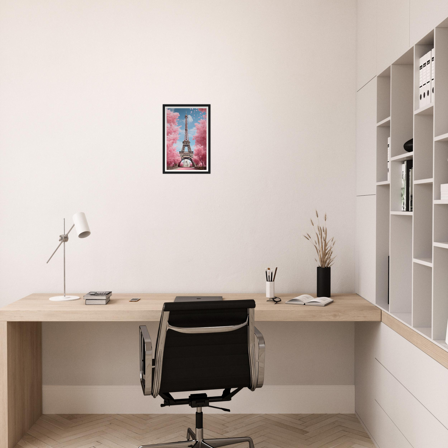 A pink flower in a vase on a desk