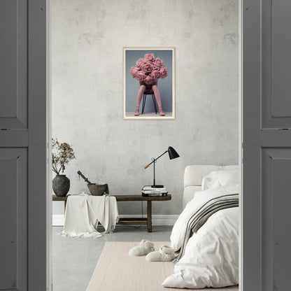 A pink flower in a vase on a grey wall