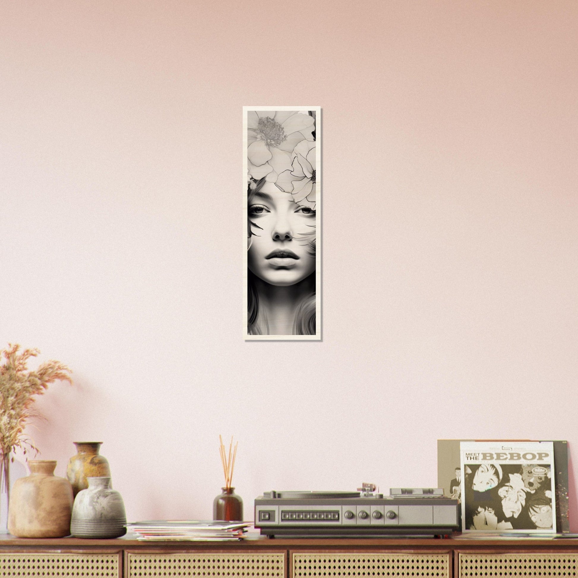 A pink wall with a black and white photo of a woman’s face