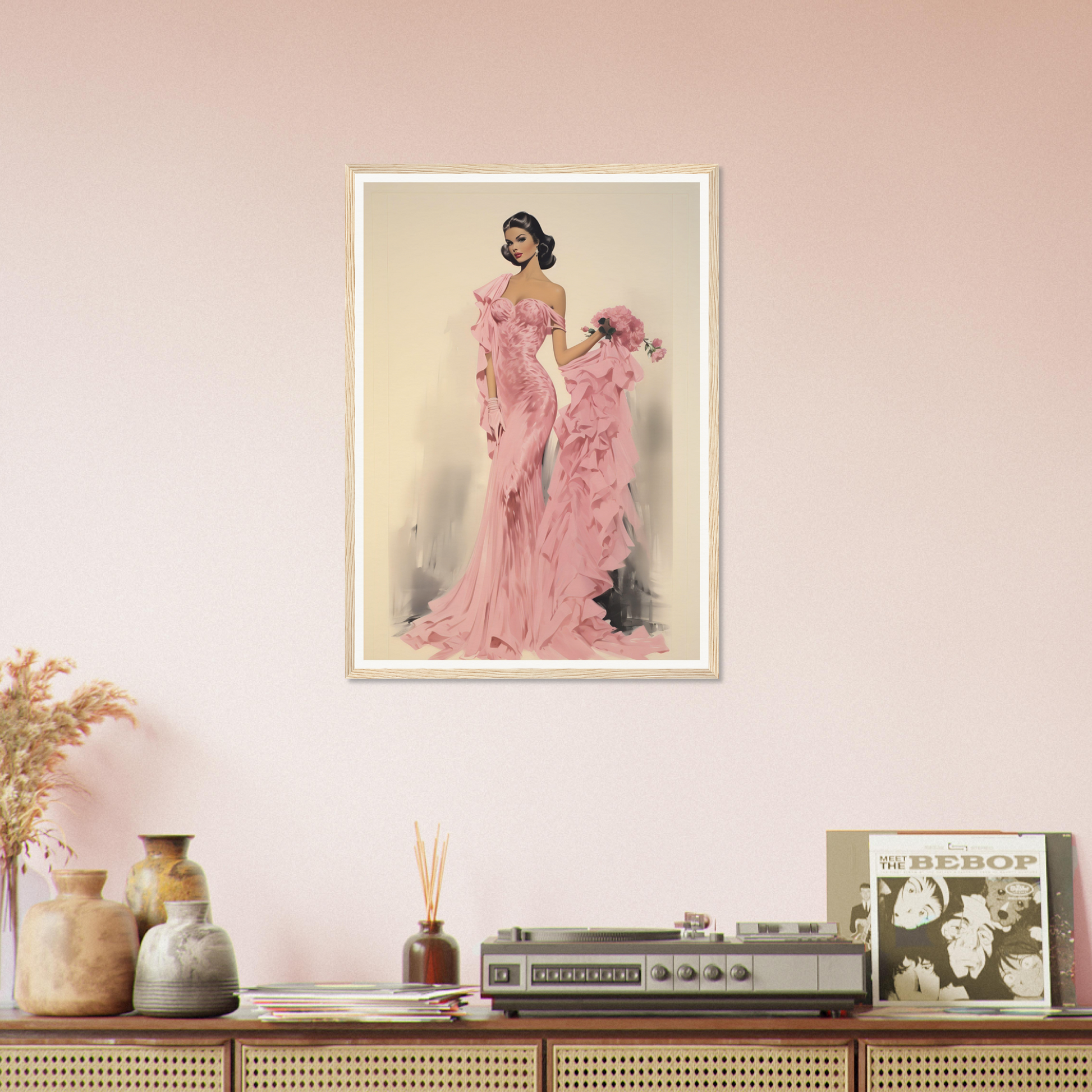 A pink wall with a framed photograph of a woman in a pink dress