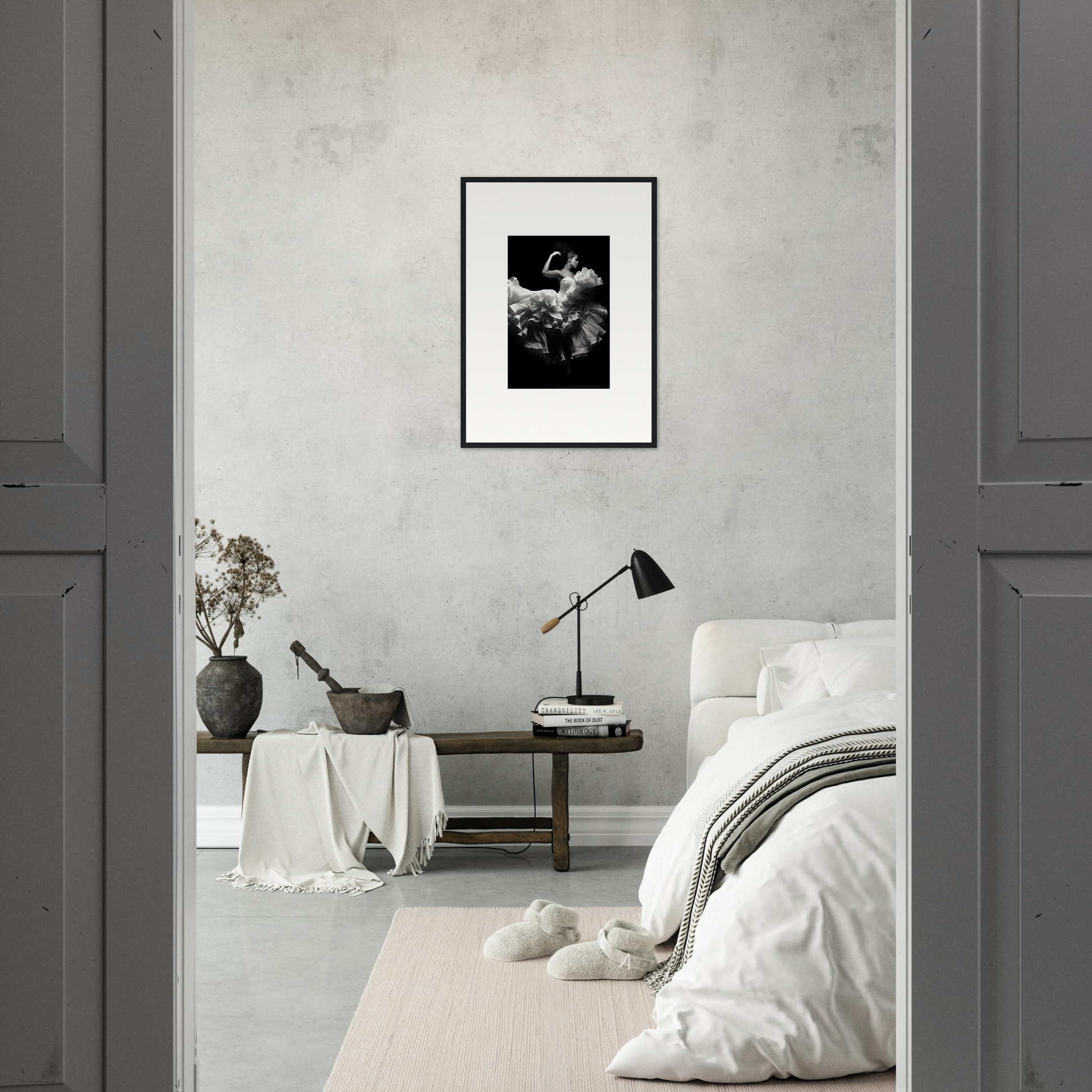 Minimalist bedroom with a black and white framed photograph as the focal point.