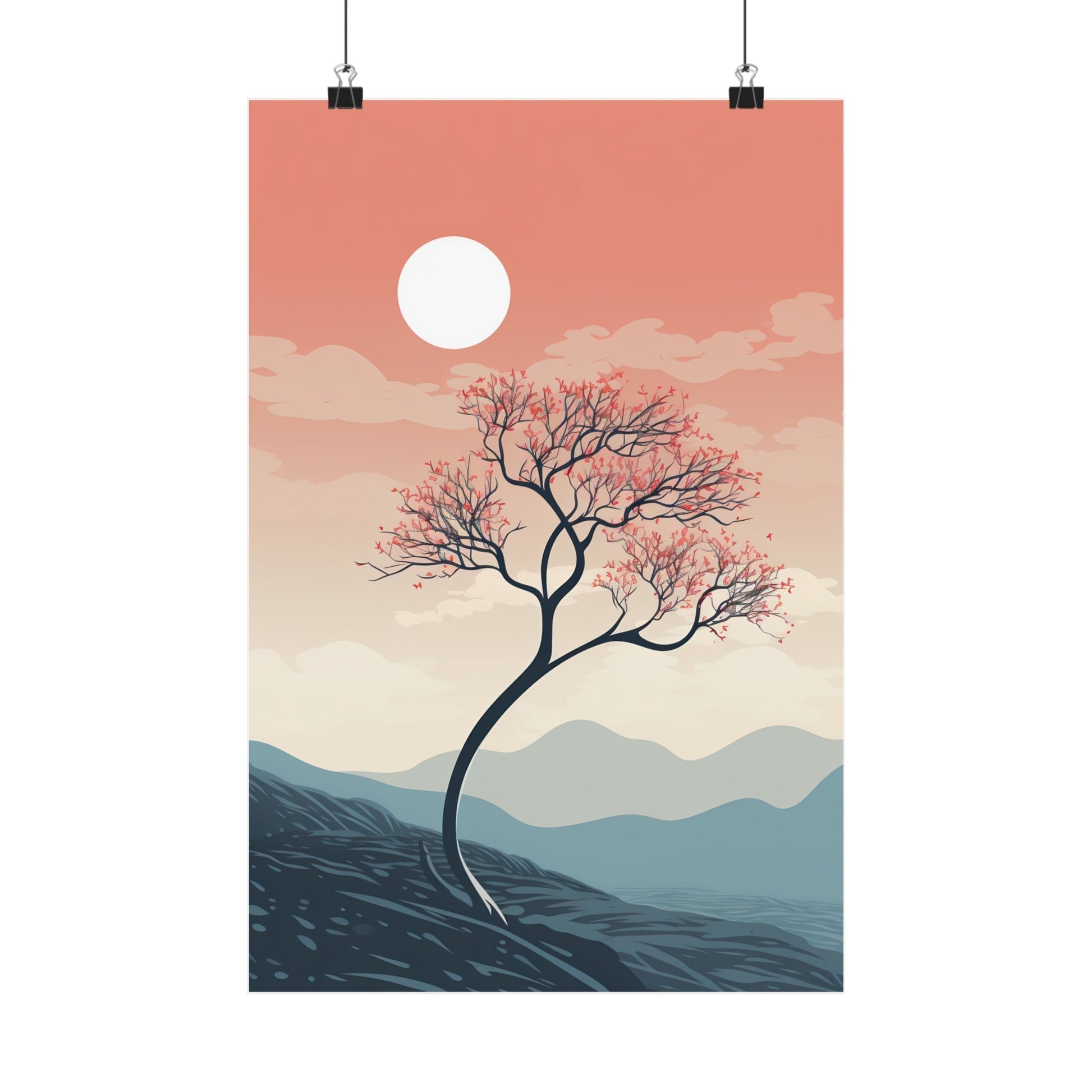 Lone tree with bare branches against a sunset sky and mountainous landscape.