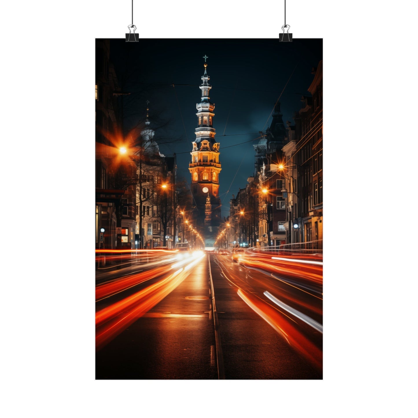 Illuminated city street at night with light trails and a prominent tower in the distance.