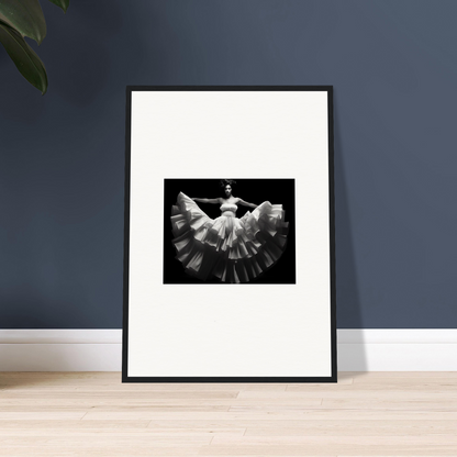 Framed black and white photograph of a dancer in a flowing dress with outstretched arms.