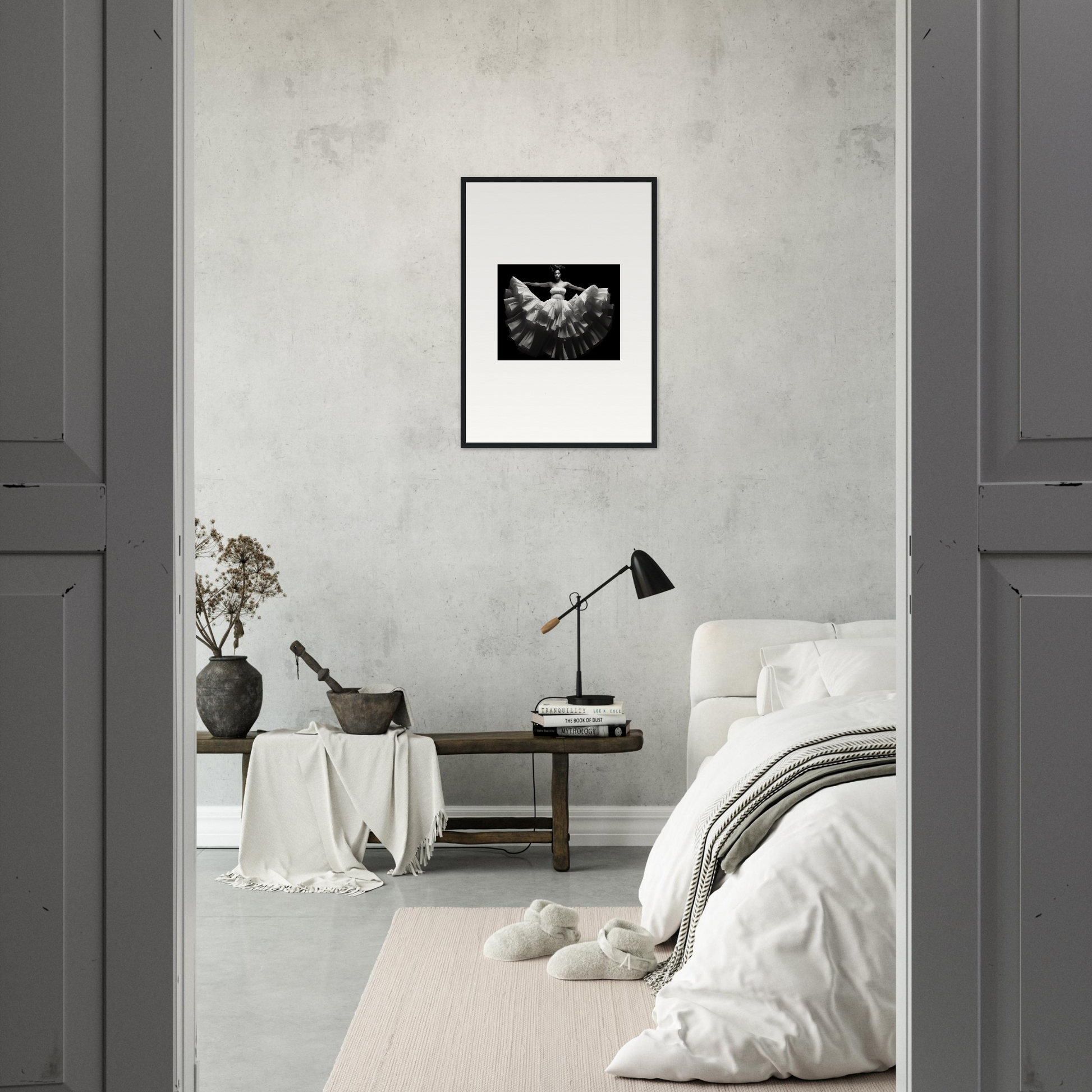 Minimalist bedroom with a framed black and white artwork as the focal point.