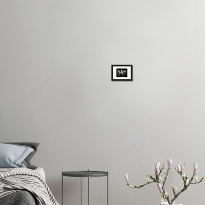 Minimalist bedroom corner with a bed, side table, and decorative plant.