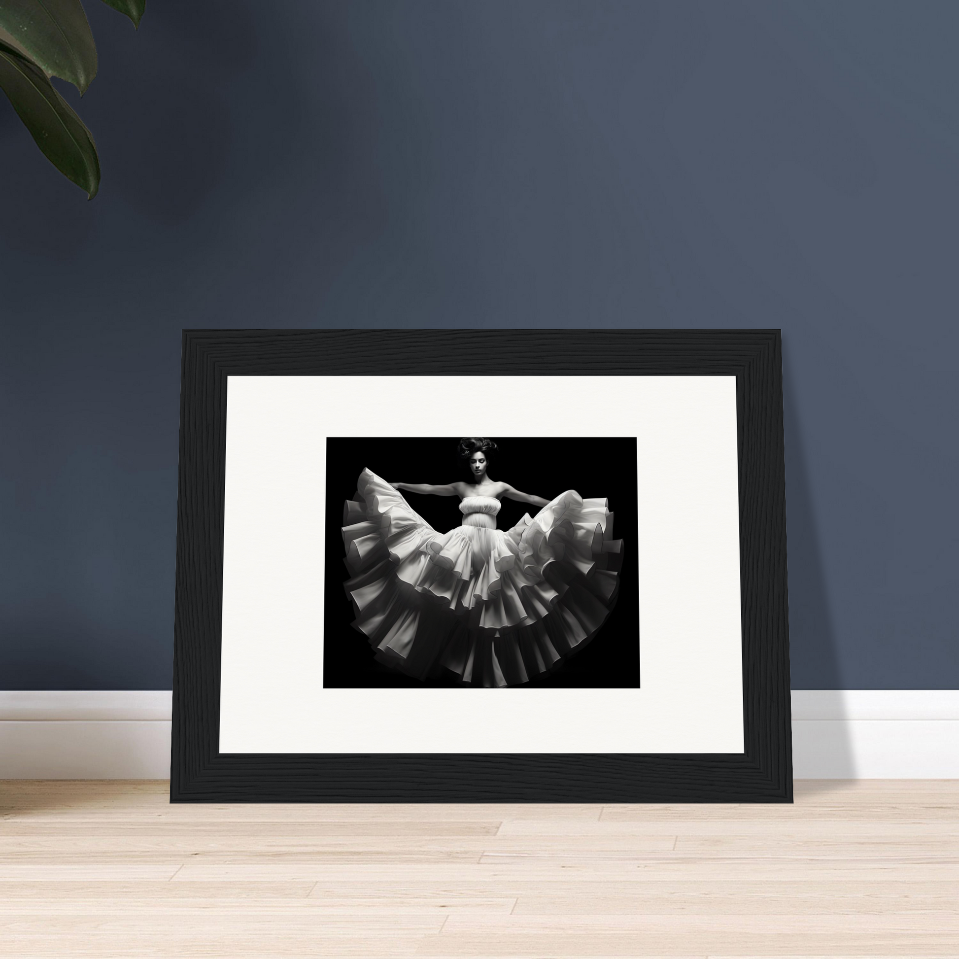 Framed black and white photograph of a dancer in a flowing dress with outstretched arms.