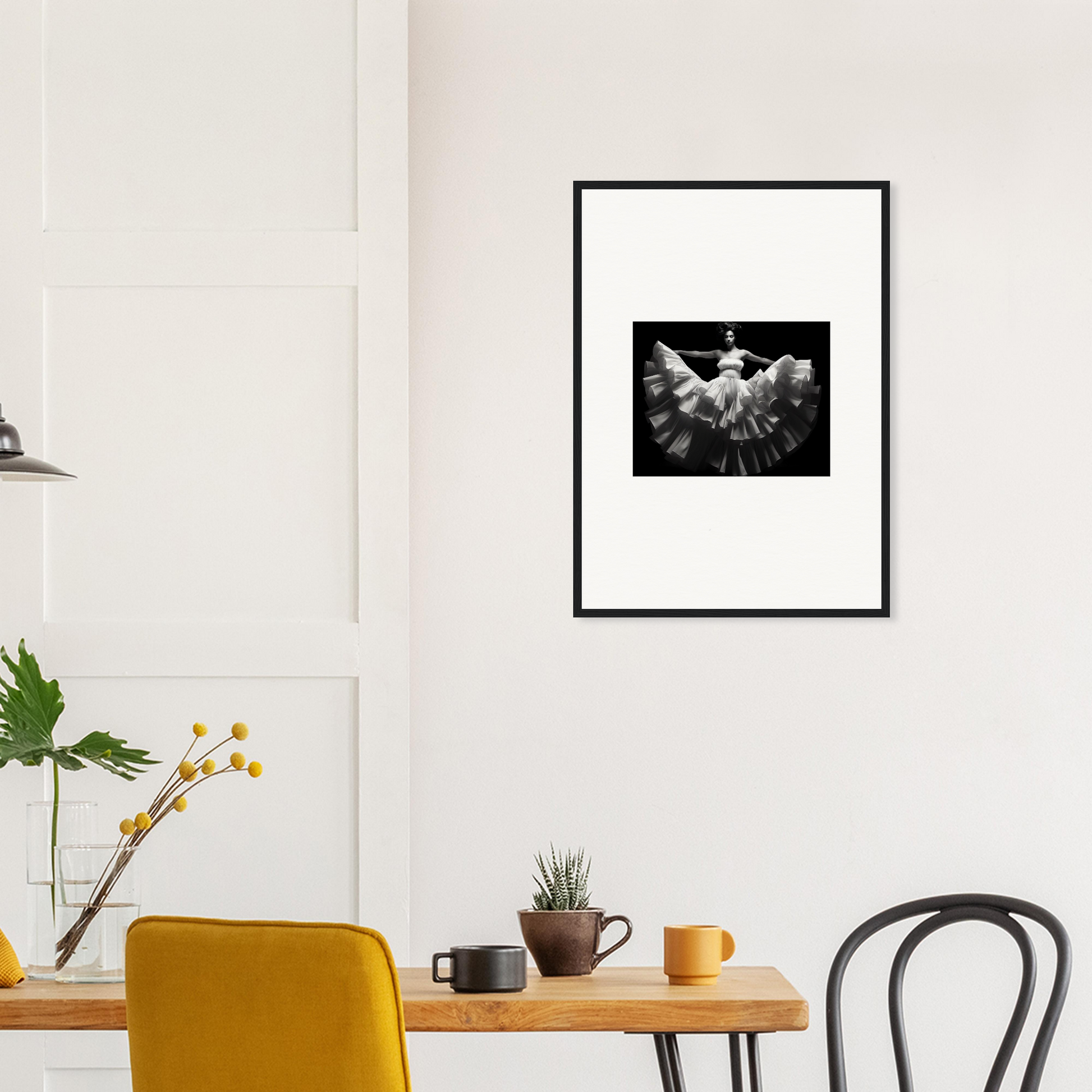 Framed black and white photograph of a figure with outstretched arms resembling wings.