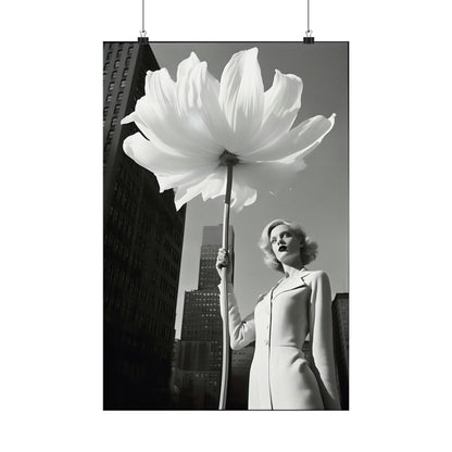 A woman holding a large white flower in front of a tall building