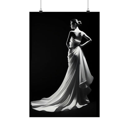 Elegant woman in a flowing white gown posing dramatically against a dark background.