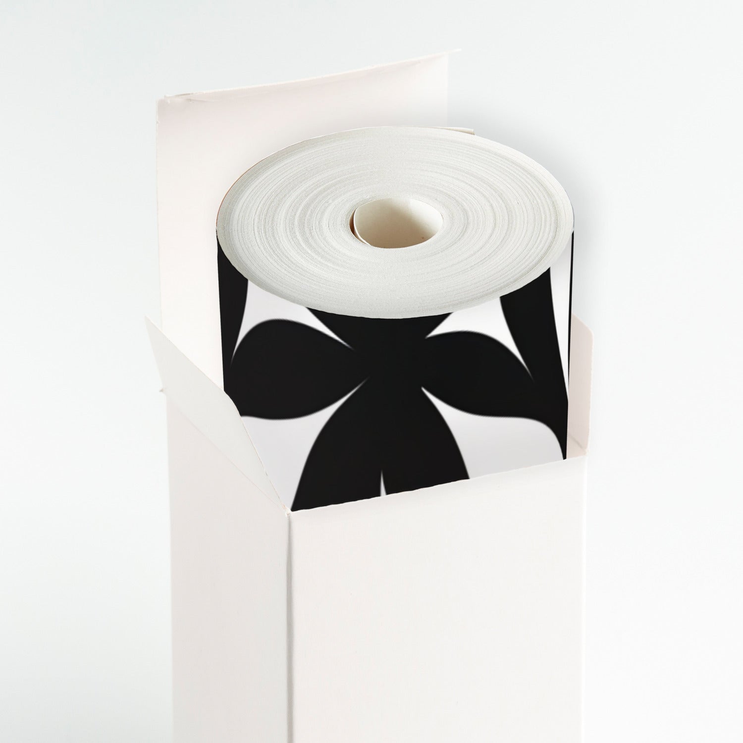 A roll of white paper with black bows on it