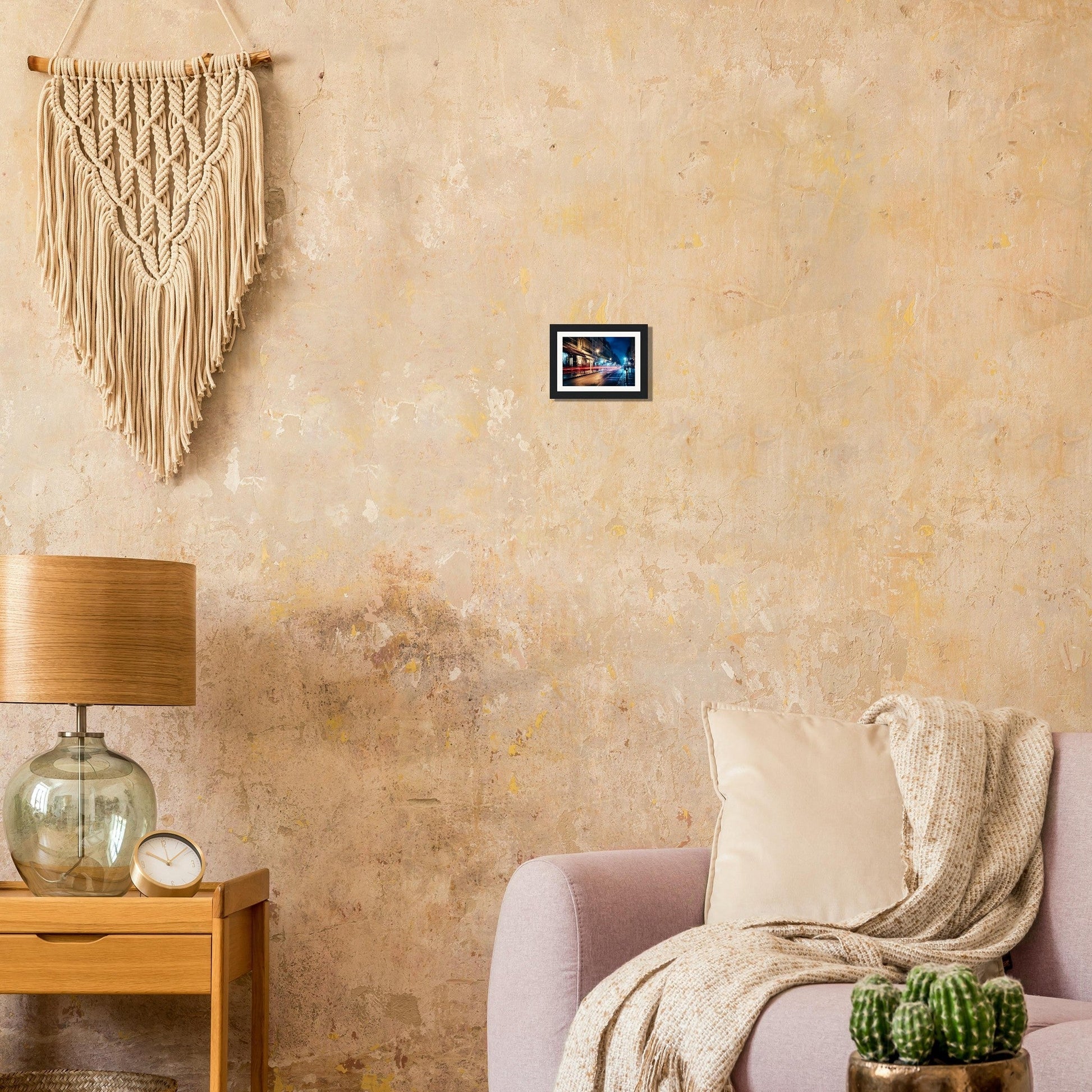 A living room with a couch, a table and a wall hanging