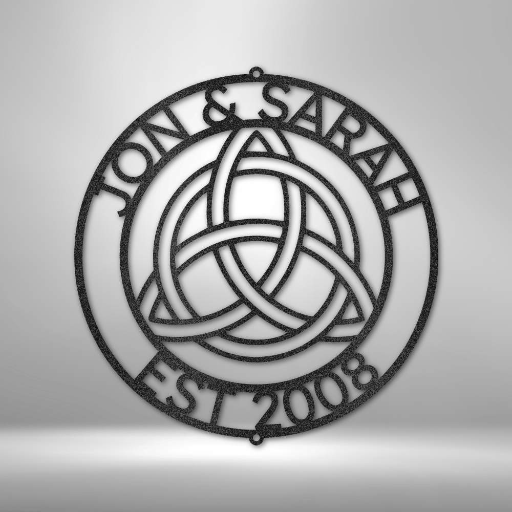 Circular metal ornament featuring a Celtic trinity knot design and text reading ’JON & SARAH EST 2008’’.