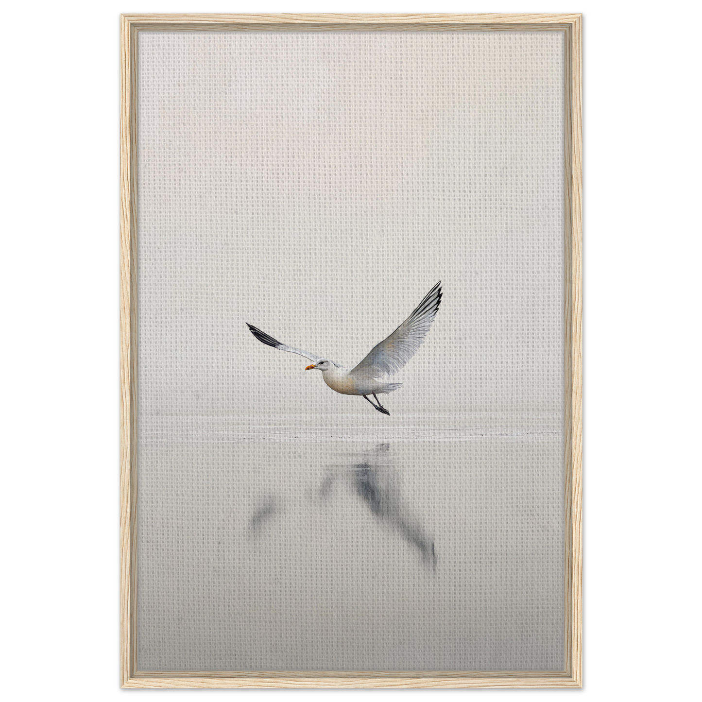 Seagull with outstretched wings flying over water in Seagull Mist Serenade framed canvas print