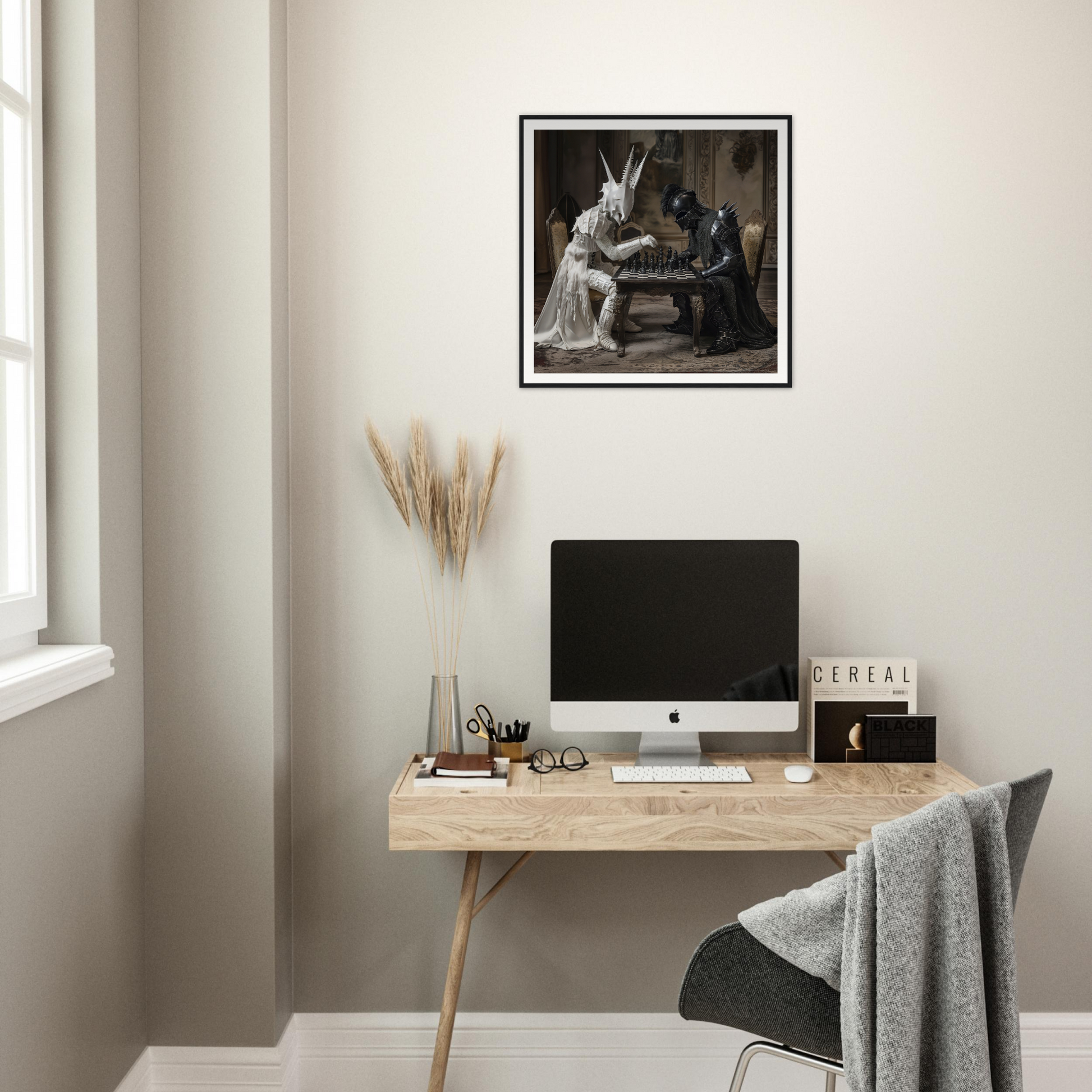 Minimalist wooden desk with iMac and Serpentine Strategists Duel framed wall art