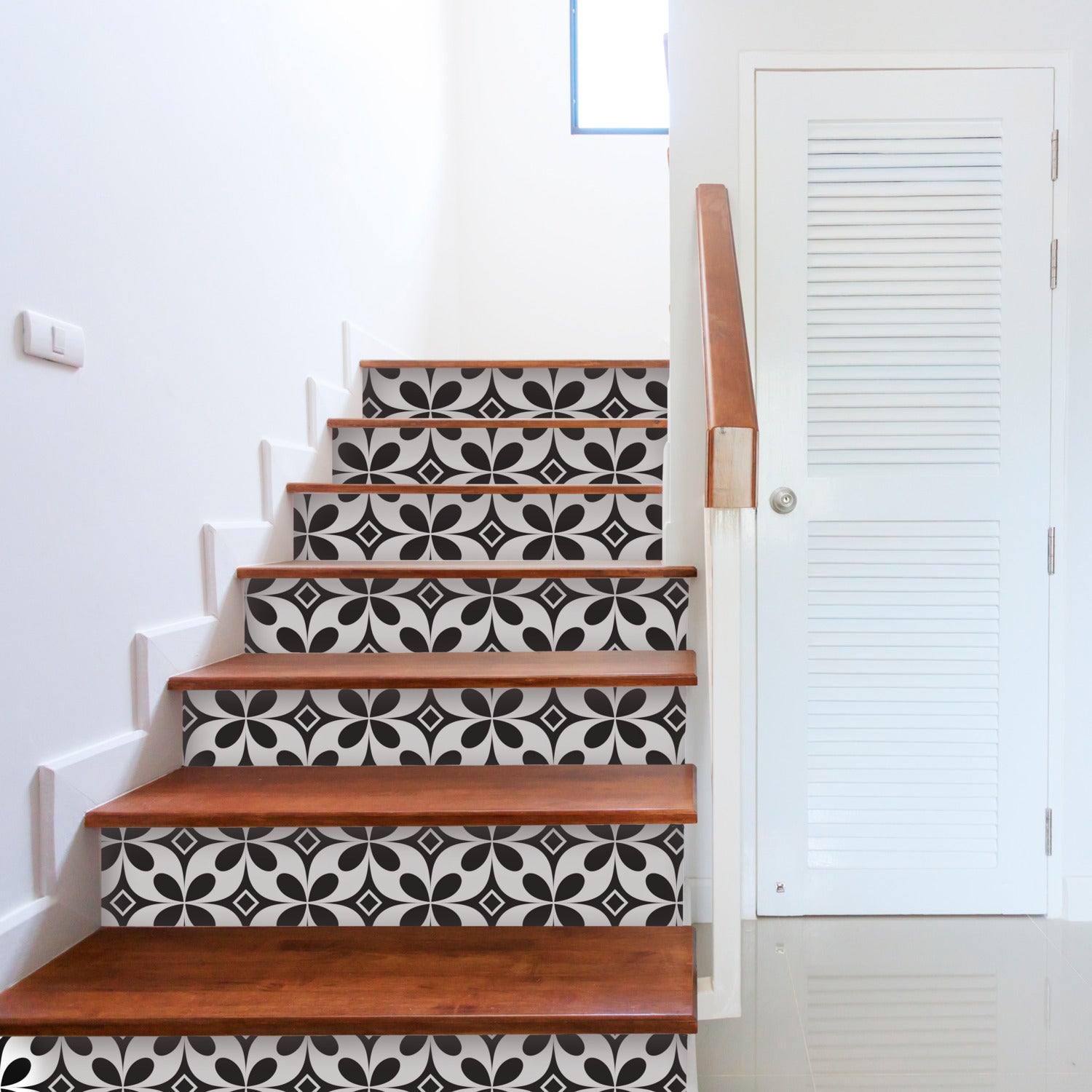 A stair with black and white tile on it