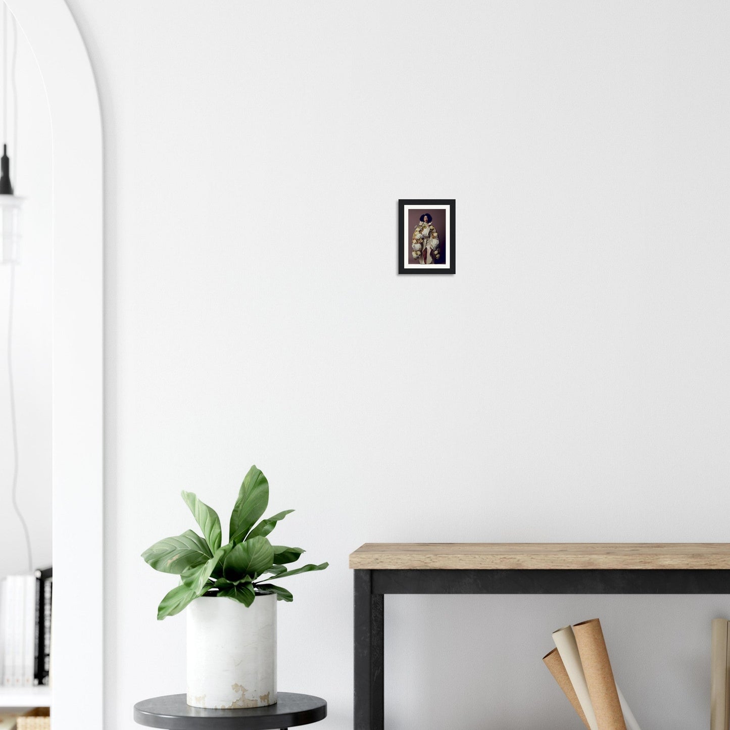 Framed photograph hanging on a white wall.