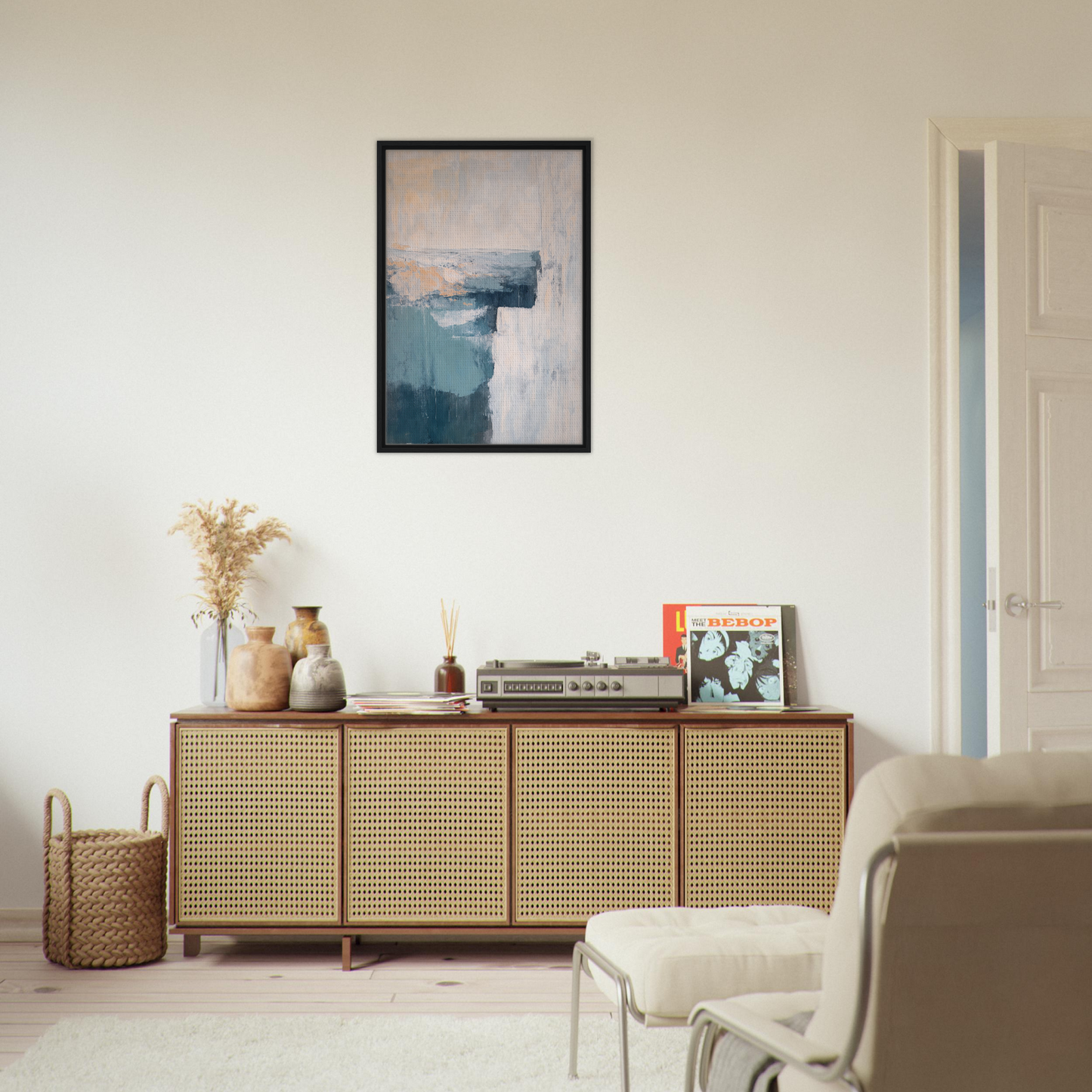 Wooden sideboard with cane-webbed doors atop Teal Horizon Dreams and decorative items