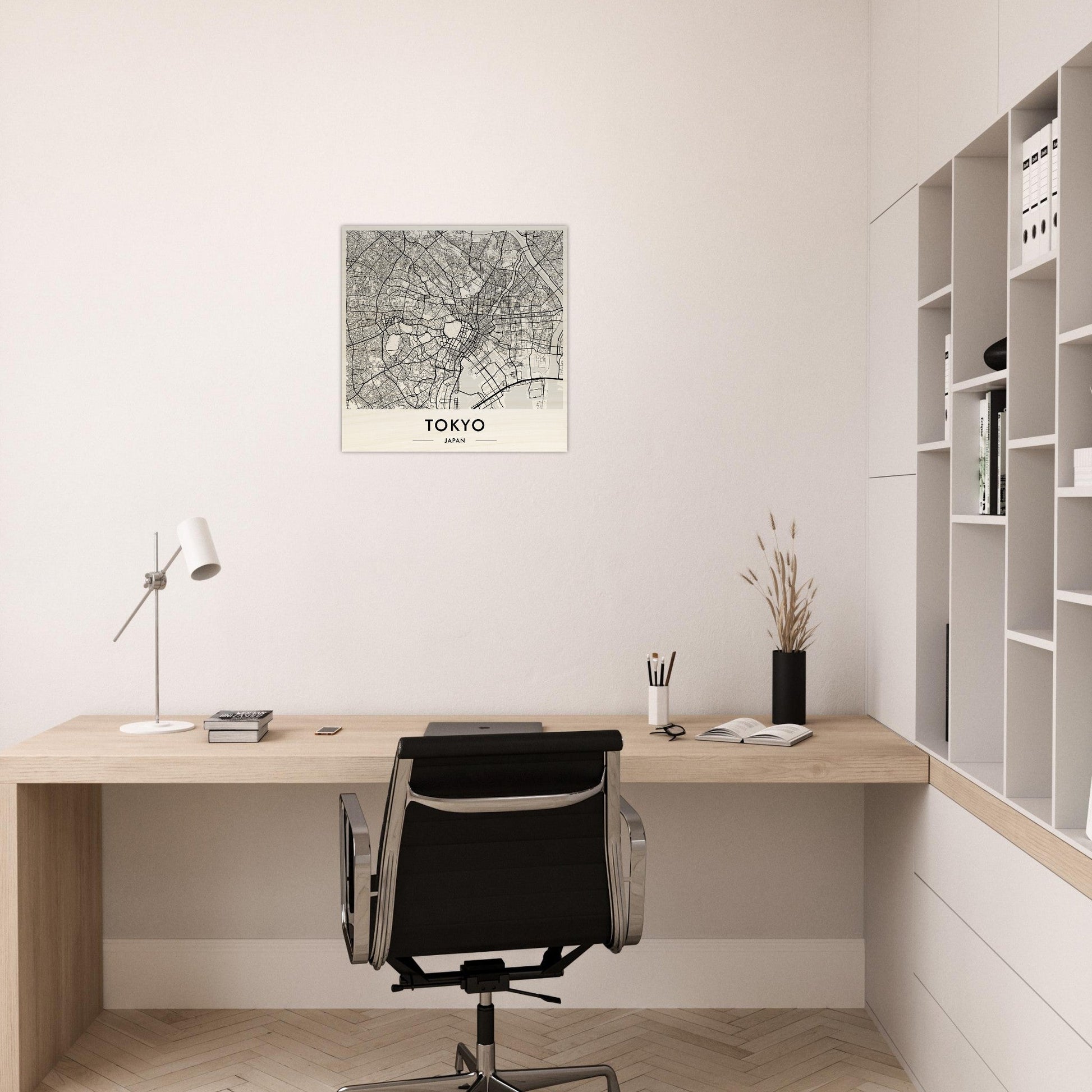 Minimalist wooden desk with a black office chair in a home workspace.