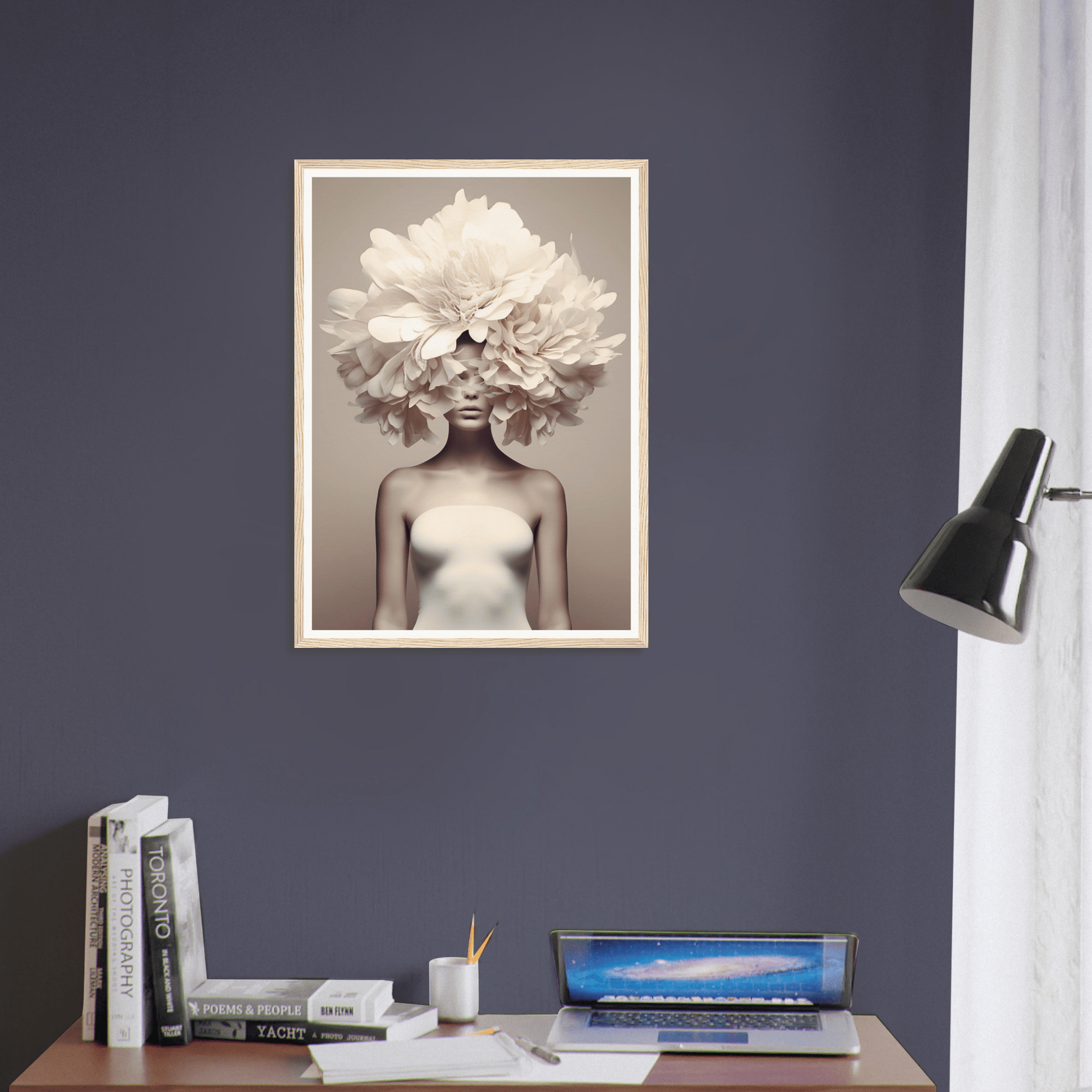 Framed black and white photograph of a figure with a large white flower covering the upper part of their head.