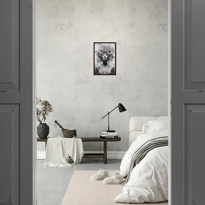 Minimalist bedroom with neutral color palette and framed artwork on the wall.