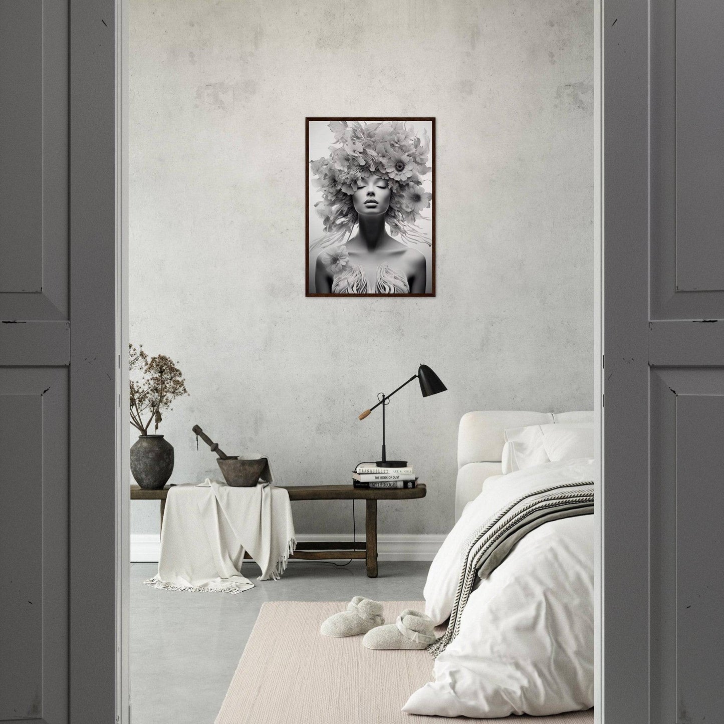 Monochrome bedroom with a striking black and white portrait as the focal point.