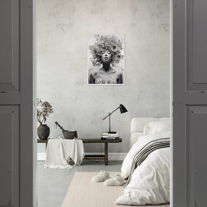 Monochrome bedroom interior with a striking black and white portrait on the wall.