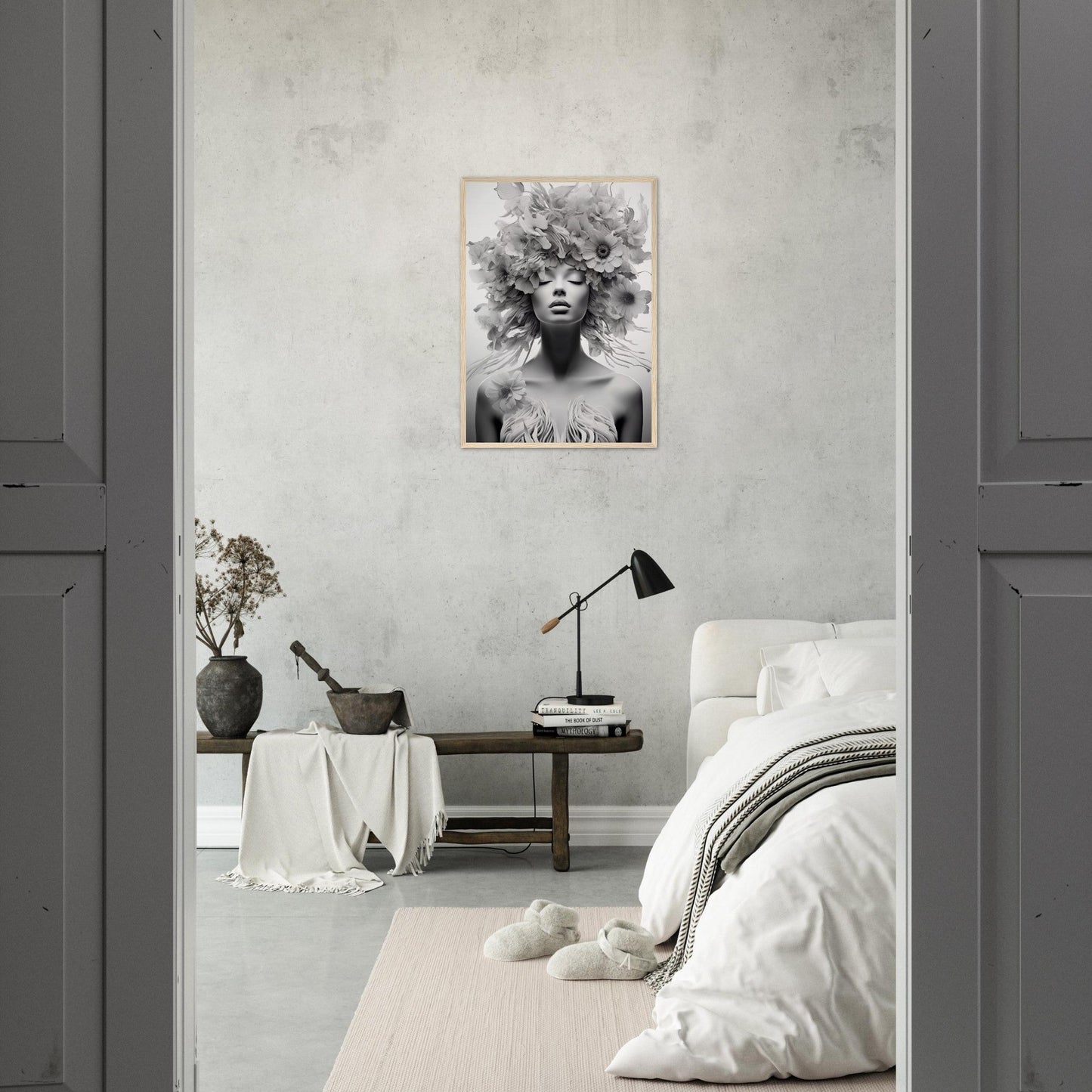 Monochrome bedroom with a striking black and white portrait as the focal point.