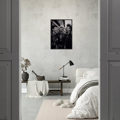 Monochrome photograph of palm fronds in a black frame hanging on a white wall.