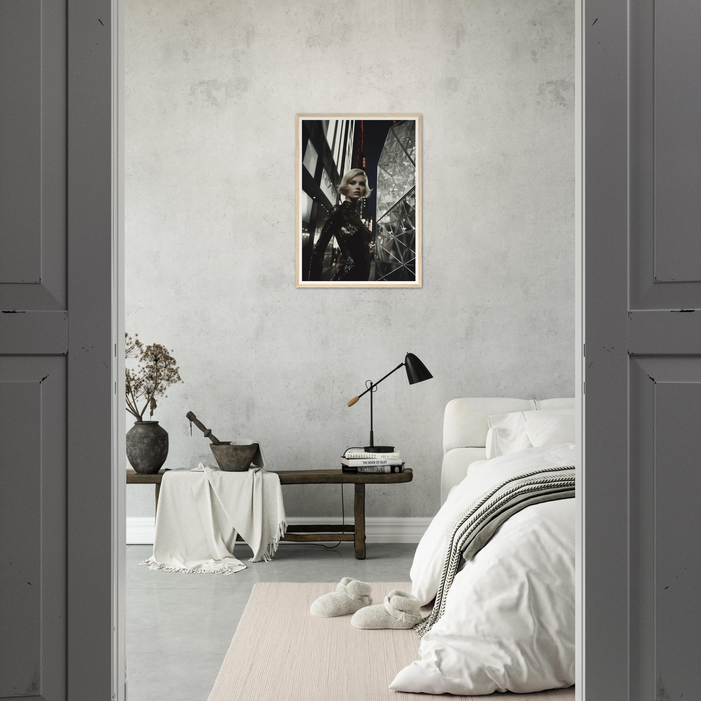 Minimalist bedroom with a black and white photograph as the focal point on the wall.