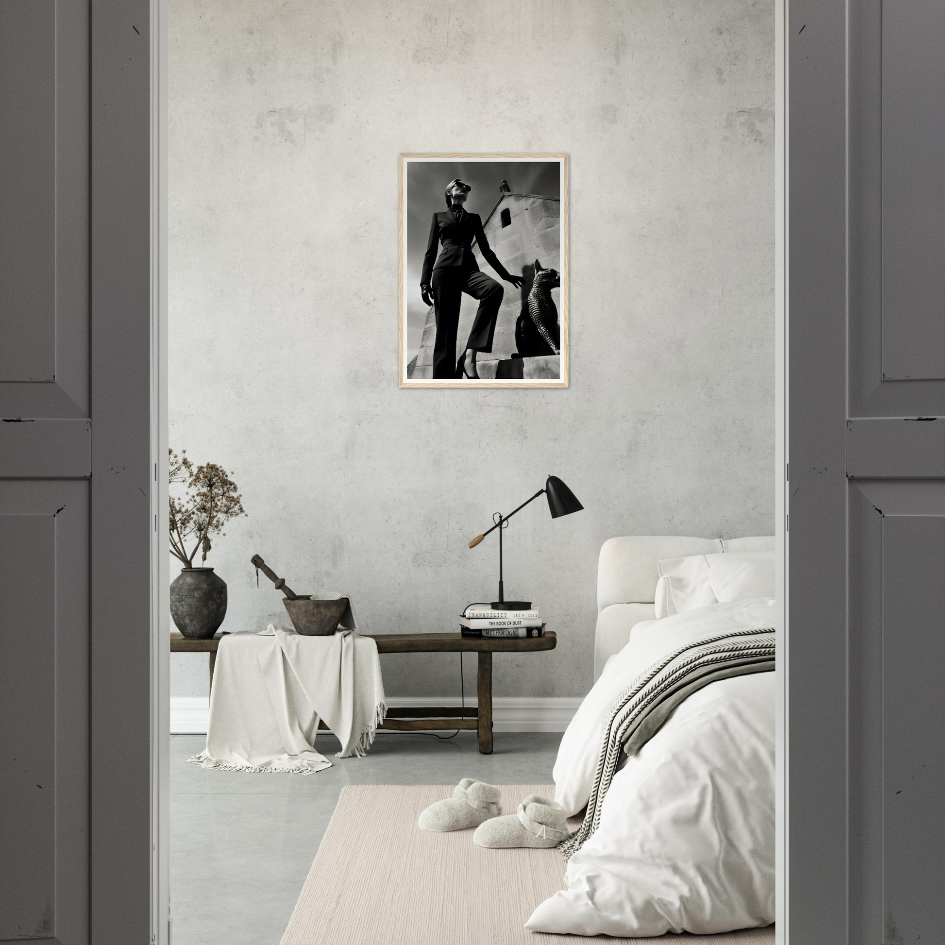 Minimalist bedroom with a black and white photograph on the wall.