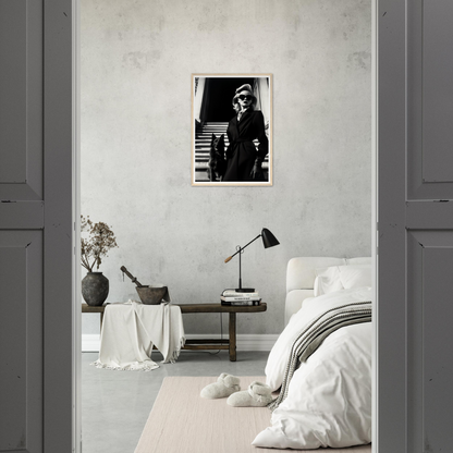 Minimalist bedroom with a black and white photograph on the wall.