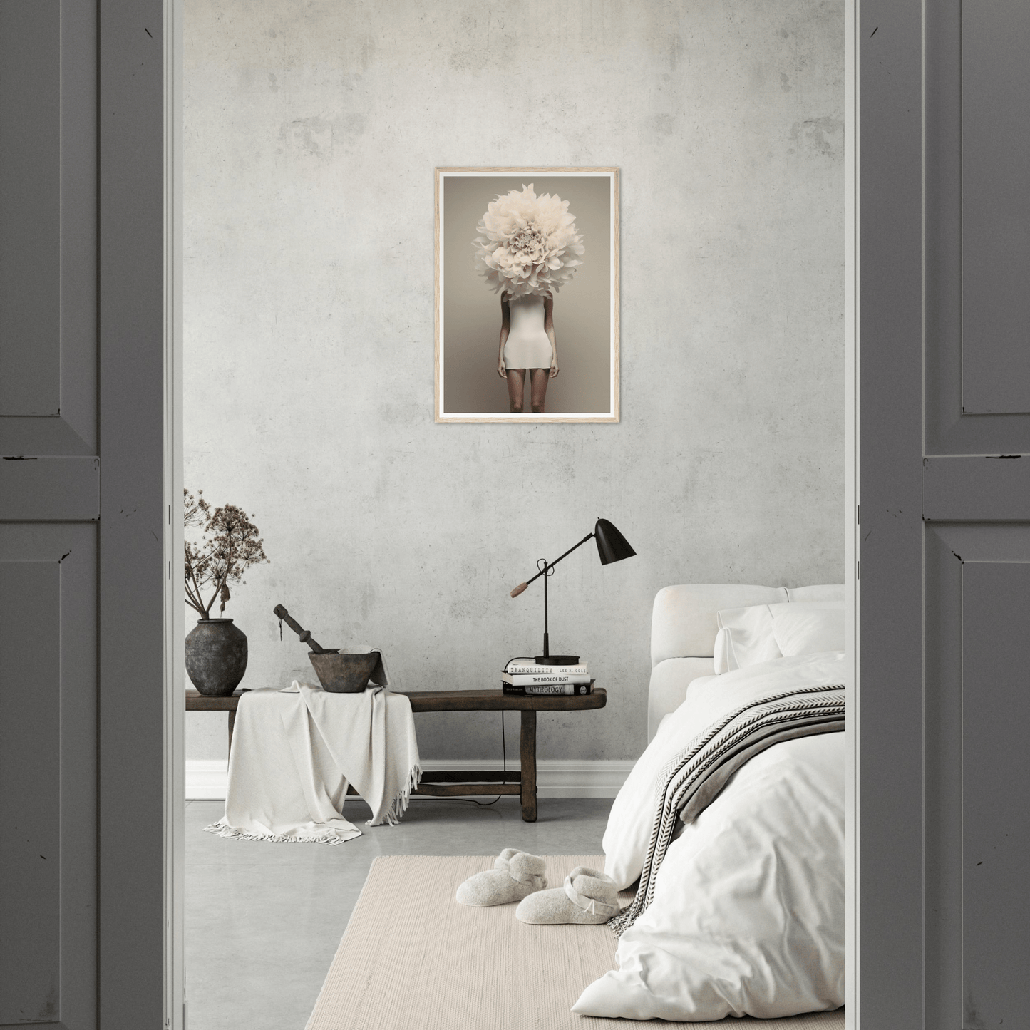 Minimalist bedroom with a surreal artwork featuring a figure with a floral head as the focal point.