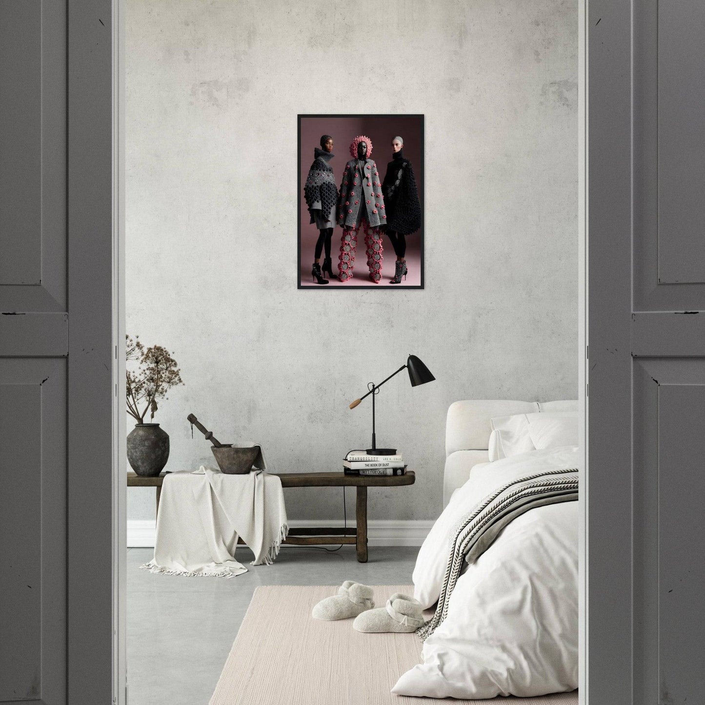 Framed portrait of three people in stylish outfits hanging on a white wall.