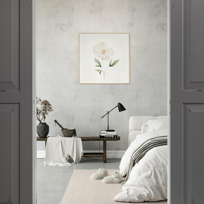 Minimalist bedroom with neutral color palette and floral wall art.