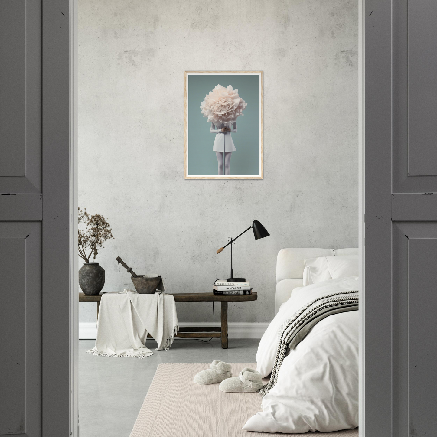 Minimalist bedroom with a framed artwork of a figure holding a large white cloud-like object.