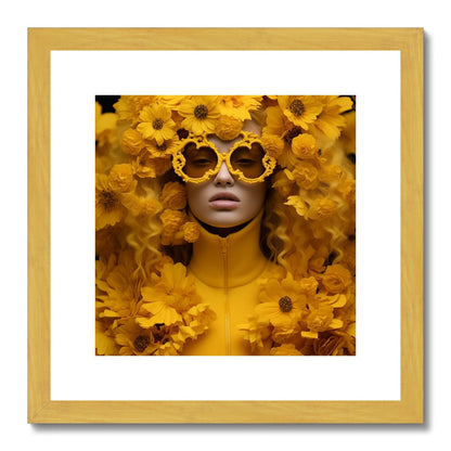 Framed photograph of a person wearing yellow sunflower-shaped sunglasses surrounded by yellow flowers.