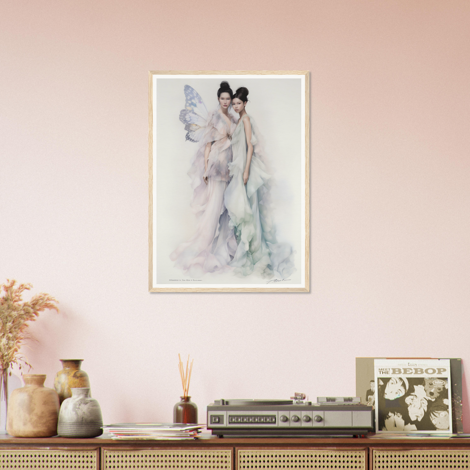 Framed watercolor painting of two figures in soft, muted tones hanging on a pale pink wall.