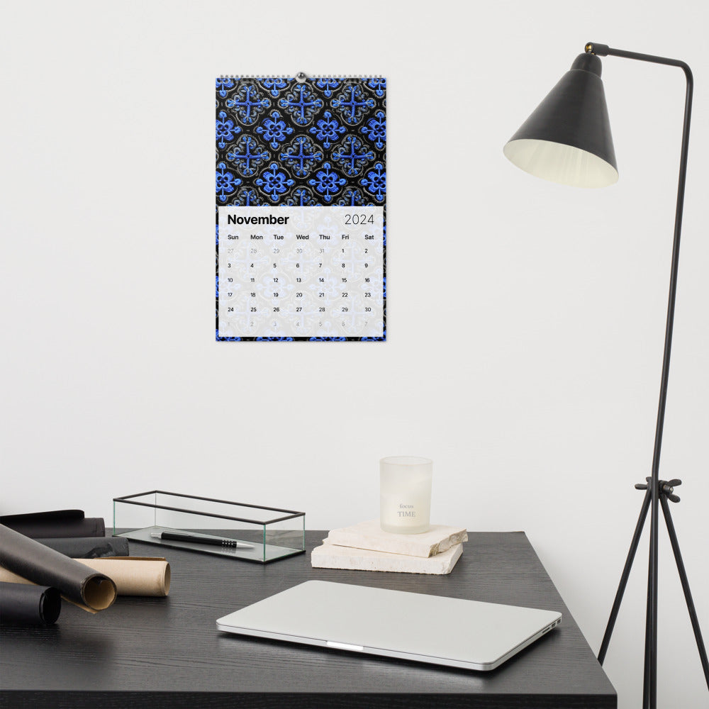 Calendar for November 2024 with a blue floral pattern background hanging on a wall.