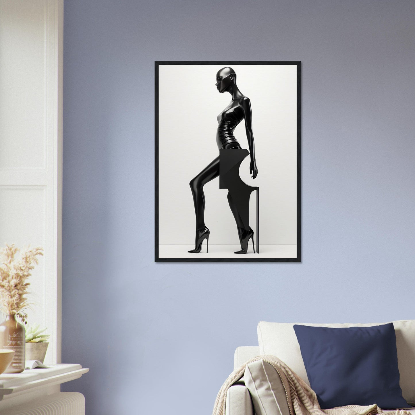 Black and white framed artwork depicting a stylized silhouette of a woman in a sleek pose.